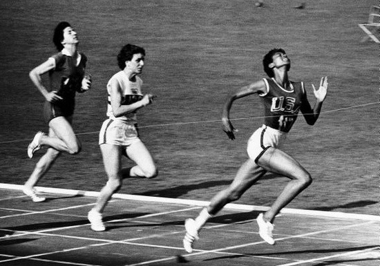 Image of women track athletes racing to the finish line.