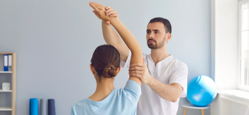Image of a physical therapist assisting a client in a stretch.