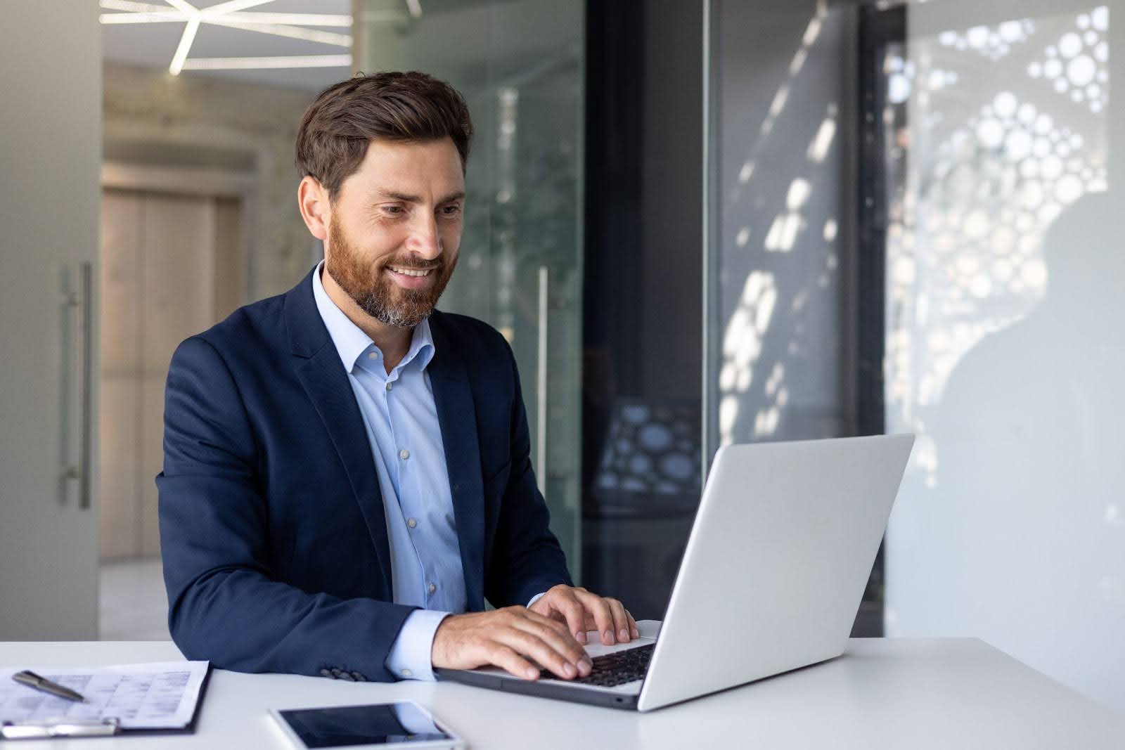 a man working on a laptop in office
