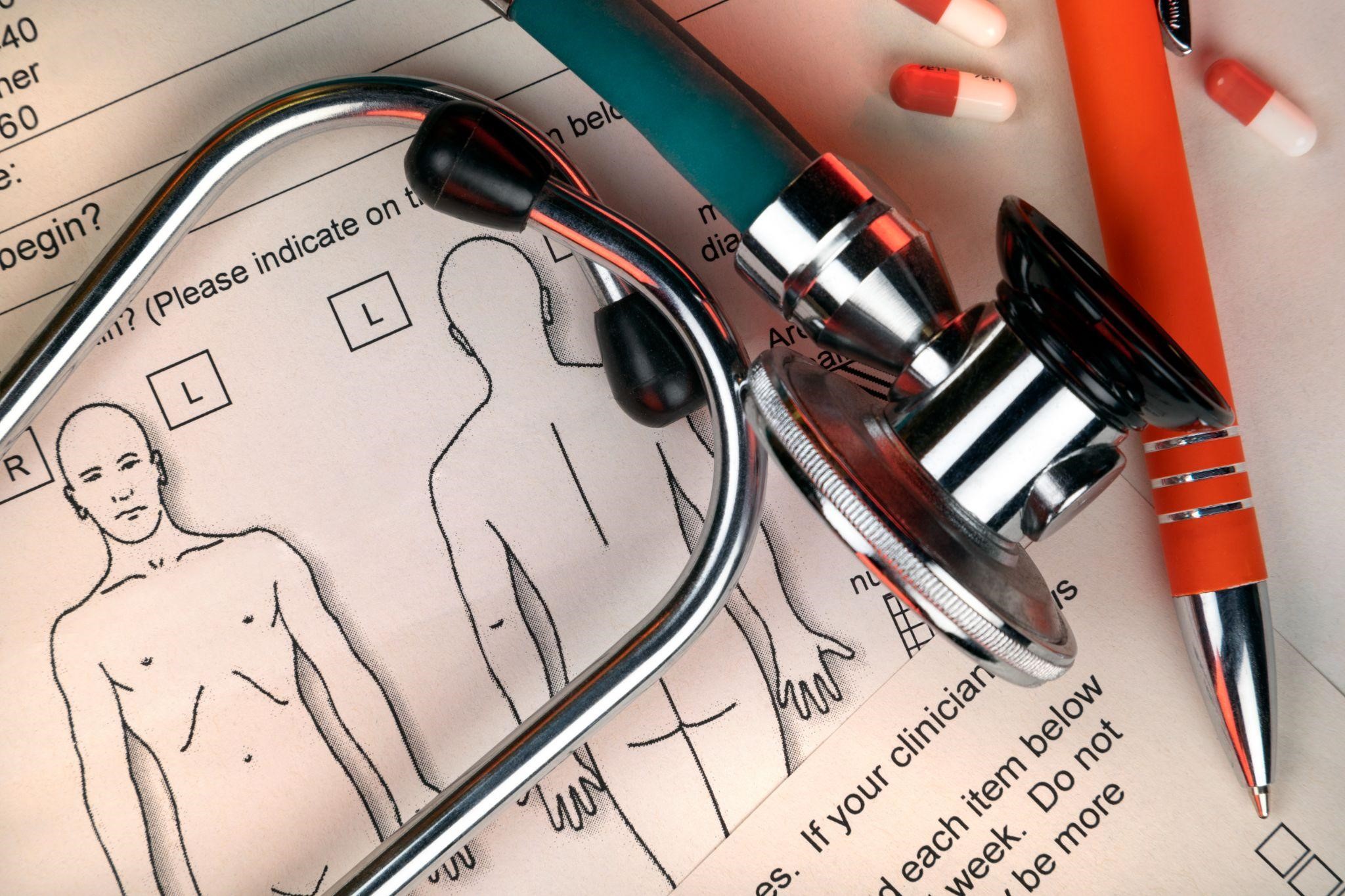 Stethoscope and body diagram on a medical chart, representing kinesiology, anatomy, and clinical terminology